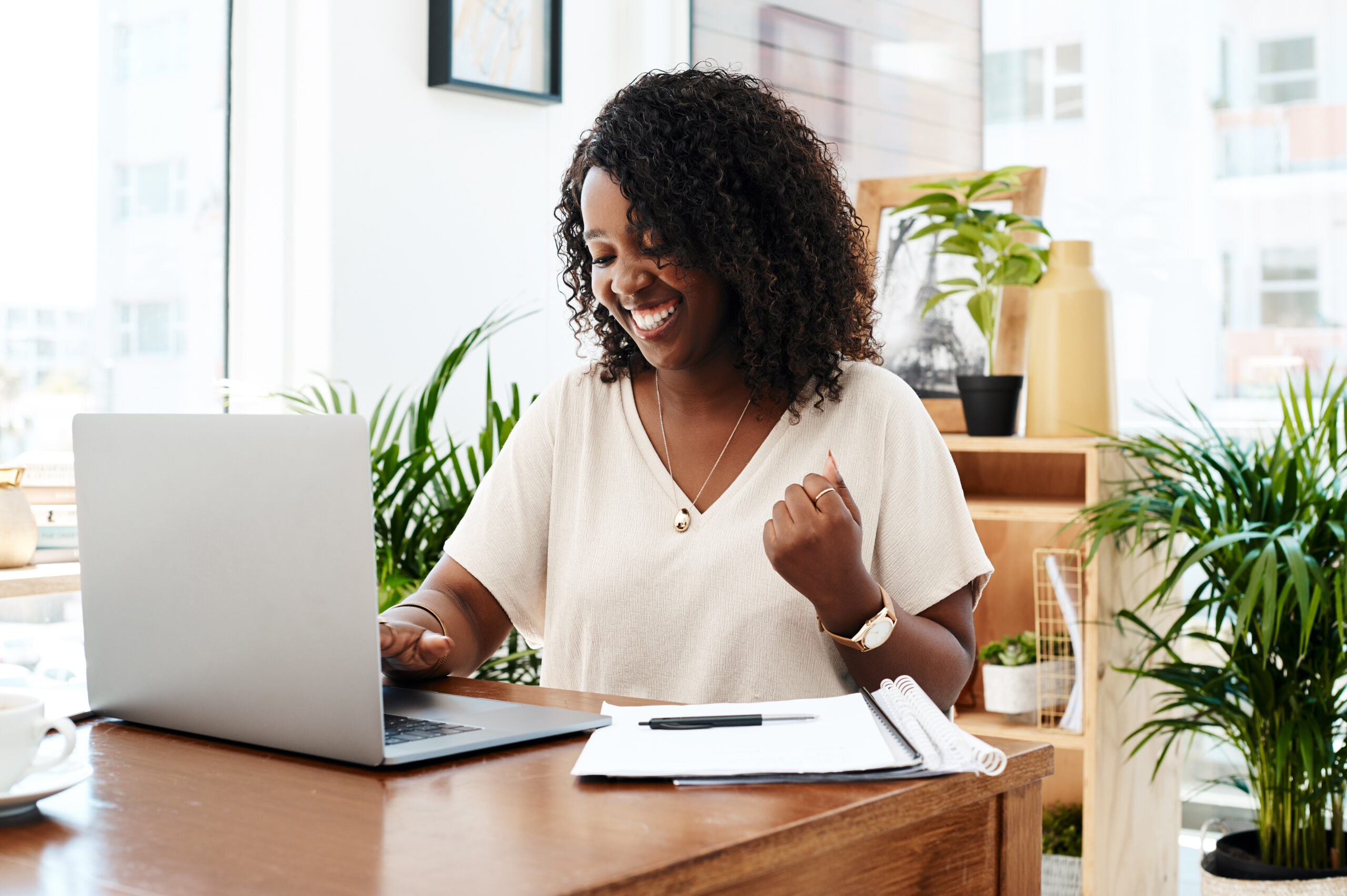 Emerging as a winner yet again. Black woman receiving great news as she excitedly gleams at her laptop.