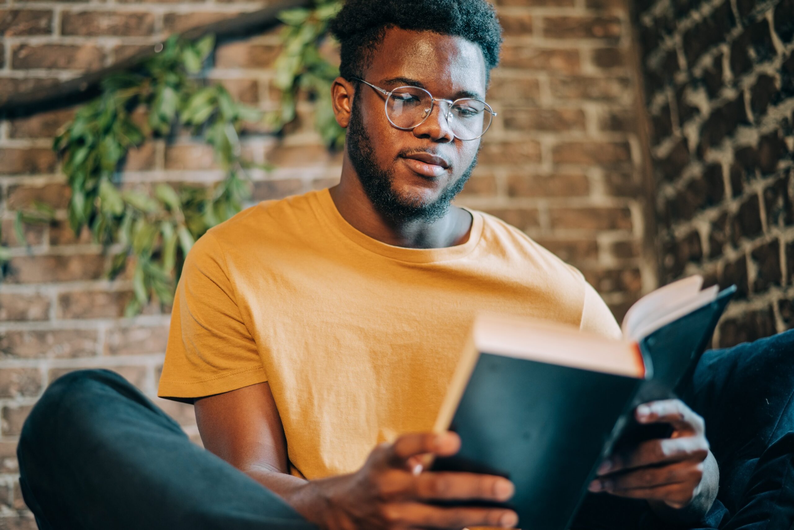 young-man-reading-the-book-si-2026-01-05-04-56-41-utc african american young man reading a book